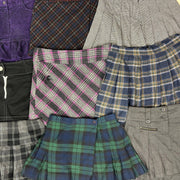 Assorted autumn winter mini skirts in various plaid patterns and colors including purple, gray, pink, blue, green, and black .