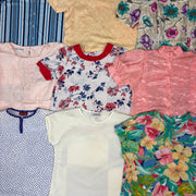 Assorted vintage short sleeve blouses in floral, striped, polka dot, and solid patterns with various colors and necklines.