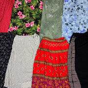 Collection of assorted vintage summer skirts with floral, polka dot, and patterned designs in vibrant colors.