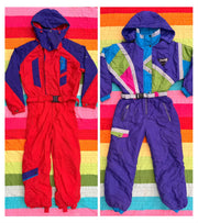 Two vintage ski suits, one red and blue and one purple with colorful geometric panels, displayed on striped backgrounds.