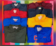 Assorted coach jackets in red, navy, blue, yellow, and olive, with snap fronts and assorted chest details.